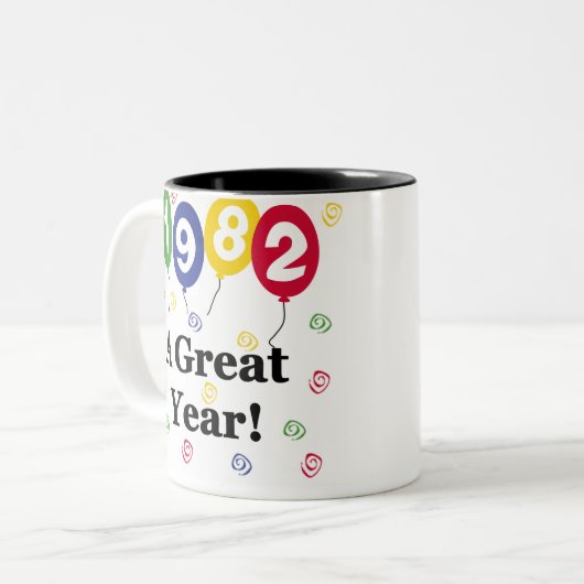 1982 een grote jaardag tweekleurige koffiemok (Voorkant links)