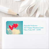 2 Helderrode kopballonnen die naar boven drijven Etiket (Insitu)