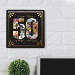 50th Wedding Jubileum Black en Gold Photo Vierkante Klok<br><div class="desc">Creëer uw eigen unieke 50th Wedding Jubileum wandklok met een paar van uw favoriete foto's van de afgelopen 50 jaar. Dit elegante zwarte en goudontwerp kenmerkt een aantal 50 vormde fotocollage met een lijst van de kunstdecostijl en manuscripttypografie. De foto collage houdt vierkant, landschap en portret afbeeldingen, om u veel...</div>