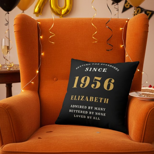 70th Birthday Gift Personalized 1956 Black Gold Kussen (Personalized 70th birthday throw pillow on an orange velvet wingback chair)