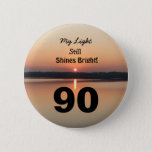 90th Birthday My Light Still Shines Bright Button<br><div class="desc">Give a happy 90th birthday button to express his "My Light Still Shines Bright" gevoel. A bold design with a black and gold sunrise on a peaceful lake sends a message of stimuland love. An endearing verse for an inspiring ninetieth birthday celebration</div>