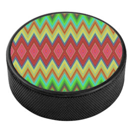 A circular speaker with a vibrant, zigzag pattern hockey puck