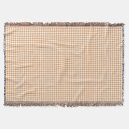A gingham checkered blanket in shades of beige  deken