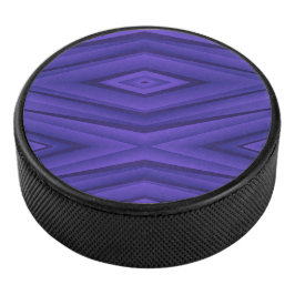 A hockey puck with a vibrant purple geometric 