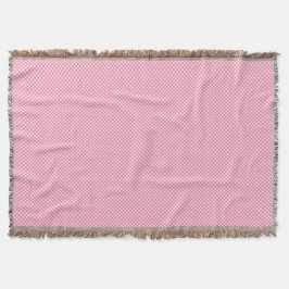 A pink woven blanket with a subtle pattern  deken
