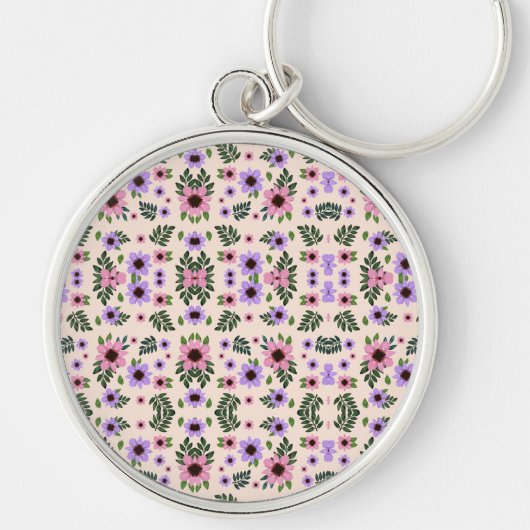 A round keychain featuring a vibrant floral  (Voorkant)
