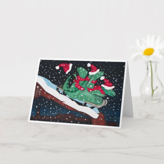 A whimsical holiday card with sledding dinosaurs kaart (Kleine Plant)