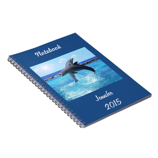 Aangepaste dolfijnen die in de oceaan spelen en tr notitieboek (Rechterzijde)