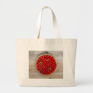 Aardbeiencake met nertsbladeren op een bijtend hou grote tote bag
