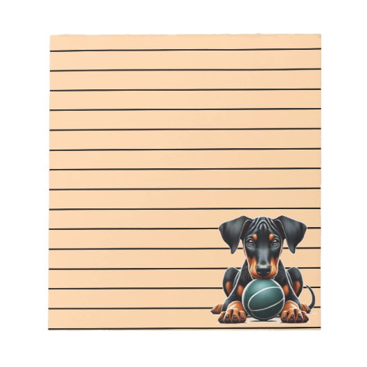 Aardige Dobermann-puppy die met een bal speelt Notitieblok (Voorkant)