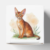 Abessijnse kat omringd door zachte kleuren en groe bedankdoosjes (Bovenkant)