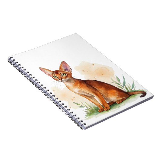 Abessijnse kat omringd door zachte kleuren en groe notitieboek (Rechterzijde)
