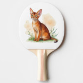 Abessijnse kat omringd door zachte kleuren en groe tafeltennisbatje (Voorkant)