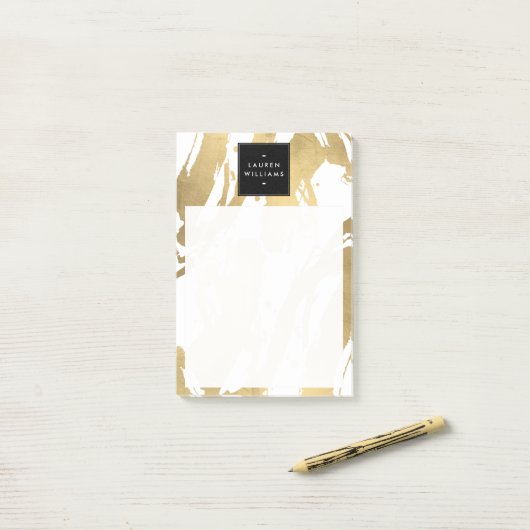 Abstracte Faux Gold-penseelstreken op wit Post-it® Notes (Op bureau)
