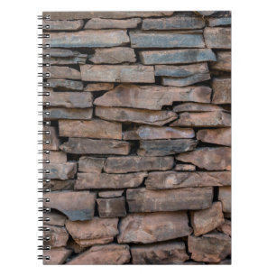 Achtergrondabstract van de oude steenwandtextuur,  notitieboek