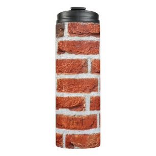 Achtergrondgebouw van de muur van een brick thermosbeker