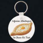 Adjarian Khachapuri Sleutelhanger<br><div class="desc">Adjarian Khachapuri is a traditional Georgian dish from the region of Adjara, located along the Black Sea coast of Georgia. It is a boat-shaped bread made from soft yeast dough, filled with melted cheese, and topped with a fresh egg yolk and a slice of butter. Before eating, the egg and...</div>