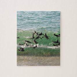 Afrikaanse pinguïns zwemmen op het strand legpuzzel