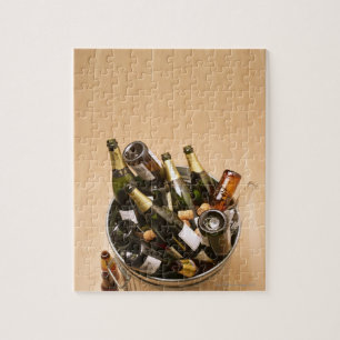 Afvalbak vol met lege champagneflessen op legpuzzel
