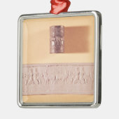 Akkadische cilinderverzegeling en indruk metalen ornament (Links)