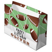 Amerikaans Football valt rond Groot Cadeauzakje (Voorkant Gekanteld)