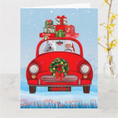 Amerikaanse eskimo-hond in auto's met kerstbedekki kaart (Gele Bloem)