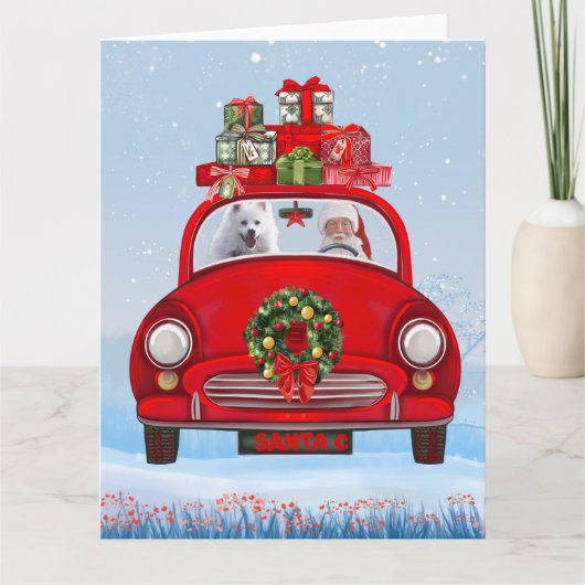 Amerikaanse eskimo-hond in auto's met kerstbedekki kaart (Voorkant)