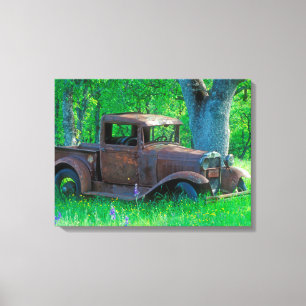 Antique rusted truck in a meadow canvas afdruk