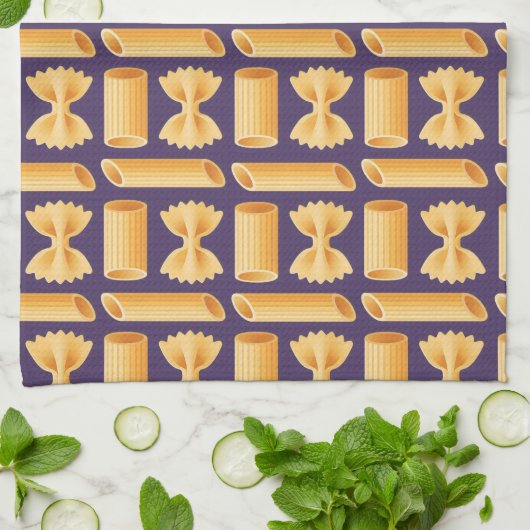 Array of various pasta shapes on a purple theedoek (Gevouwen)