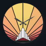 Art deco zon in zonsopgang Wandklok<br><div class="desc">Een klassiek art deco stijl zonnepatroon in dageraad kleuren. Een iconisch patroon van de zon die opkomt van achter een gestileerd art deco-vormig gebouw. Een eenvoudig maar elegant ontwerp,  trouw aan het tijdperk.</div>