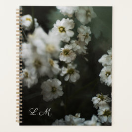 Artistiek melancholisch bloemendrieletter planner
