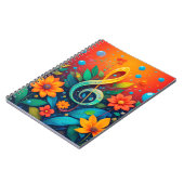 Artistieke muzieknoot omgeven door kleurrijke bloe notitieboek (Linkerzijde)