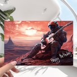 Astronaut Guitarist die gitar speelt - Birthday Kaart<br><div class="desc">Het was de dag van zijn verjaardag, en de astronaut had besloten iets speciaals te doen. Hij was in zijn tijd in de ruimte naar veel planeten geweest, maar hij was nooit bij deze geweest. Deze planeet was anders dan elke andere planeet die hij eerder had gezien, met een diep,...</div>