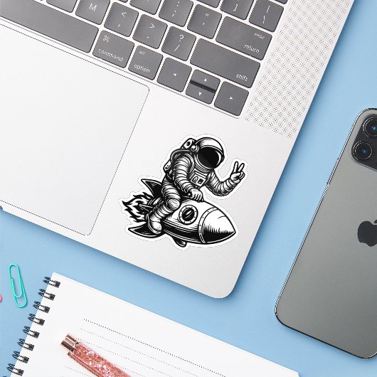 Astronaut Riding on Rocket Sticker (Laptop met iPhone)