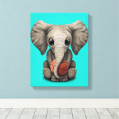 Baby Elephant Playing With Basketball Canvas Afdruk (Insitu (Houten vloer))