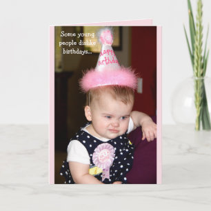 Baby looking grumpy at her first birthday party kaart