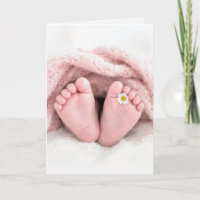 Babymeisjesvoeten met een witte madeliefje