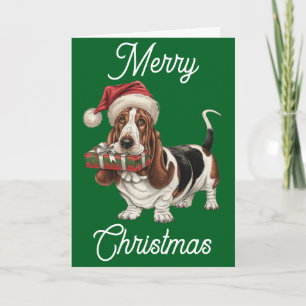 Basset Hound in kerstmuts cadeau in de bek Kaart