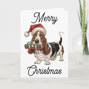 Basset Hound in kerstmuts cadeau in de bek Kaart