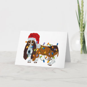 Basset in de knoop met kerstverlichting feestdagen kaart