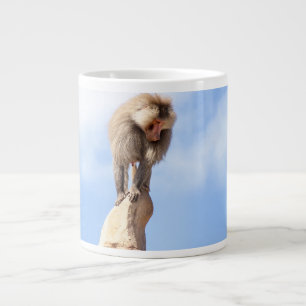 Baviaan aap boven op een berg grote koffiekop