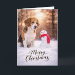 Beagle Christmas Snowman Card Feestdagen Kaart<br><div class="desc">A charming Christmas card featuring a Beagle sitting in fresh winter snow beside a cheerful little snowman wrapped in a red scarf. Warm golden winter light and softly falling snow create a peaceful holiday moment that perfectly captures the curiosity and gentle nature Beagles are known for. This card is perfect...</div>