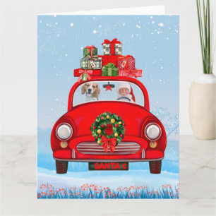 Beagle-hond in auto met kerstman kaart
