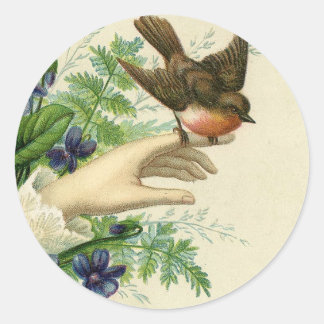 Beautiful hand with a bird and flowers ronde sticker
