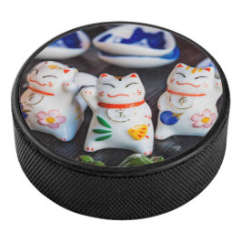 Beckoning cat figines hockey puck