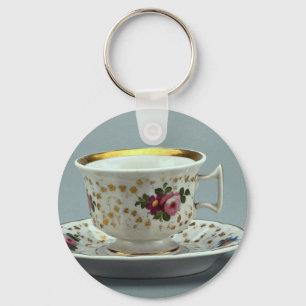 Beker en saucer met kleurrijke design erop. sleutelhanger