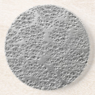 Beschadigde zilvermetalen zandsteen onderzetter