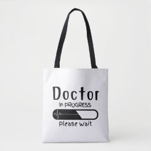 Bezig met de arts Een ogenblik geduld met de Canva Tote Bag