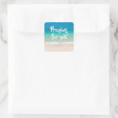 Biddend strandtafereel met blauwe oceaan vierkante sticker (Tas)