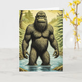Bigfoot staand in Water Cartoon Verjaardag Kaart (Gele Bloem)